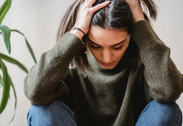 young-woman-looking-stressed-with-head-in-hands young-woman-looking-stressed-with-head-in-hands